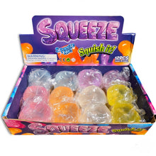Load image into Gallery viewer, A retail display box of Squeeze 'Squish it!' squishy toys, containing 12 individually wrapped translucent gelatin-like pieces in pink, orange, white, and yellow, set against a plain white background.
